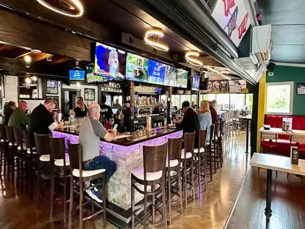 Green booths and sports jerseys on the wall