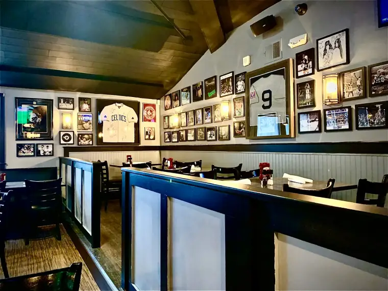 Dining room at Goat City Pub with framed sports memorabilia lining the walls