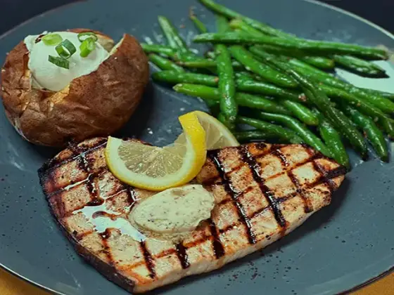 Grilled swordfish with a baked potato and green beans